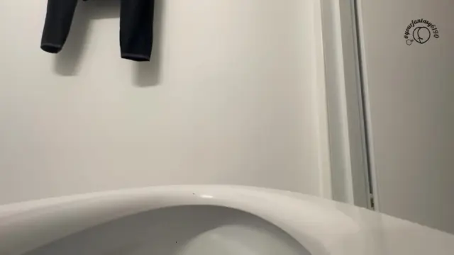 Close up shit falling in toilet
